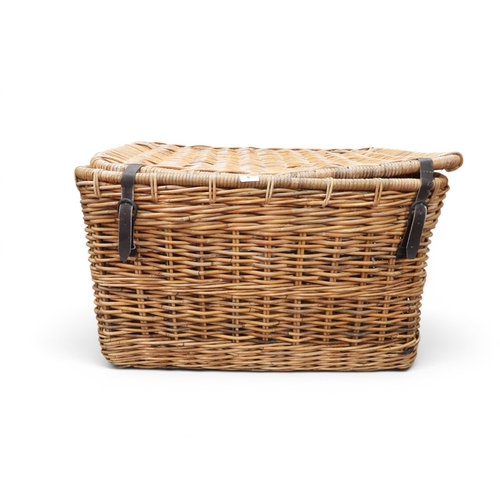 6 - A large early 20th century wicker laundry hamper with integrated handles either end and leather belt... 