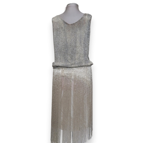 8003 - A 1920s flapper dress with scoop neckline, beaded drop waist silhouette and beaded fringe skirt, the... 