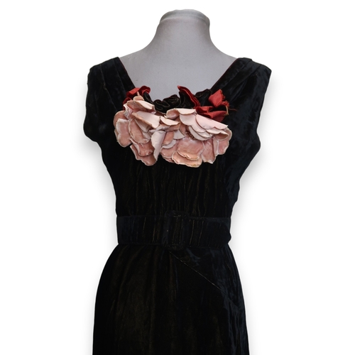8007 - A 1930s black nacré velvet evening gown with applied velvet flower corsage by Reville London; togeth... 