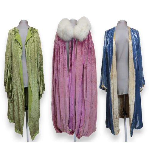 8005 - A circa 1930s pink silk velvet cape with white fox fur collar, lined with champagne satin; a blue si... 