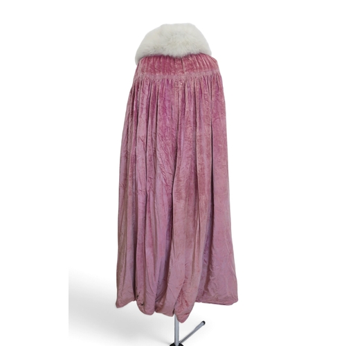 8005 - A circa 1930s pink silk velvet cape with white fox fur collar, lined with champagne satin; a blue si... 