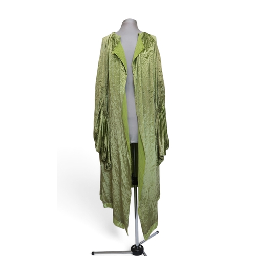 8005 - A circa 1930s pink silk velvet cape with white fox fur collar, lined with champagne satin; a blue si... 