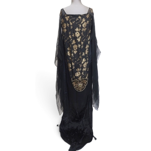8006 - A 1920s black chiffon evening dress woven with metallic threads in floral design, with chiffon hangi... 