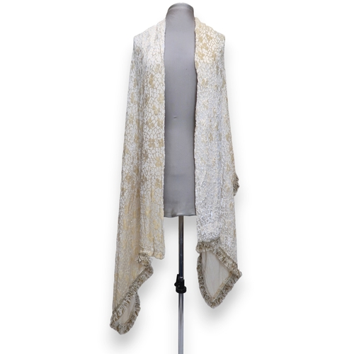 8010 - A circa 1920s cream devore shawl with passementerie fringing and an ermine fur shawl lined with chin... 