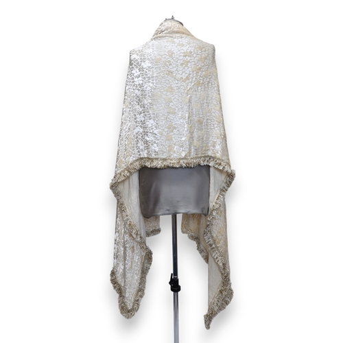 8010 - A circa 1920s cream devore shawl with passementerie fringing and an ermine fur shawl lined with chin... 