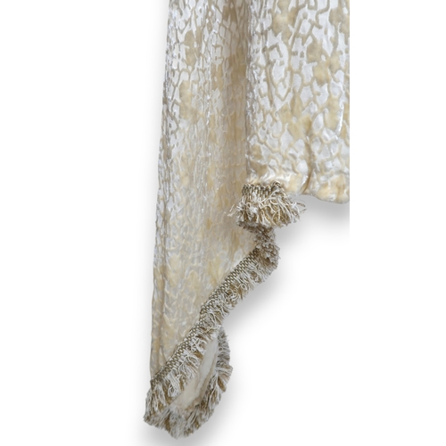 8010 - A circa 1920s cream devore shawl with passementerie fringing and an ermine fur shawl lined with chin... 