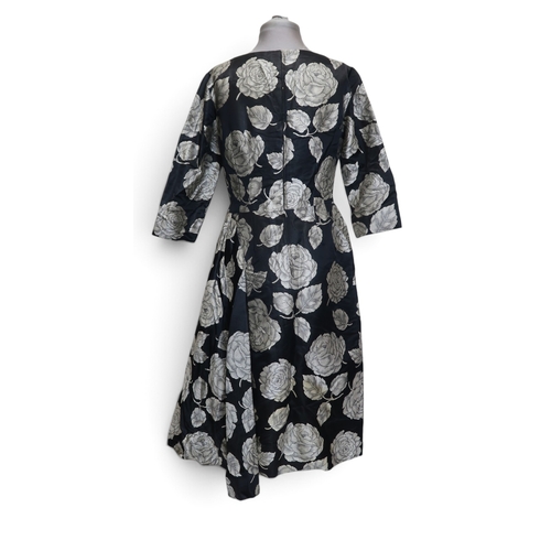 8015 - Three 1950s couture Norman Hartnell dresses comprising a black velvet cocktail dress with beaded swe... 