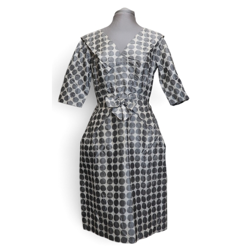 8015 - Three 1950s couture Norman Hartnell dresses comprising a black velvet cocktail dress with beaded swe... 