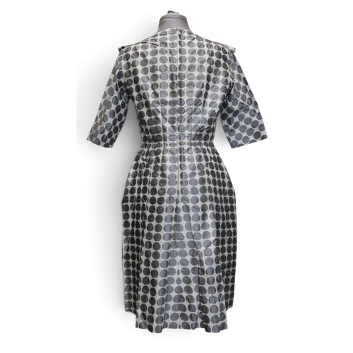 8015 - Three 1950s couture Norman Hartnell dresses comprising a black velvet cocktail dress with beaded swe... 