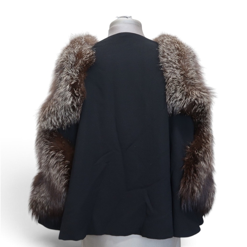 8020 - *Amended* A 1920s fur trimmed black cape by Reville London, a black shawl with silver lamé leaf-patt... 
