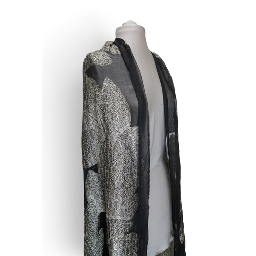 8020 - *Amended* A 1920s fur trimmed black cape by Reville London, a black shawl with silver lamé leaf-patt... 