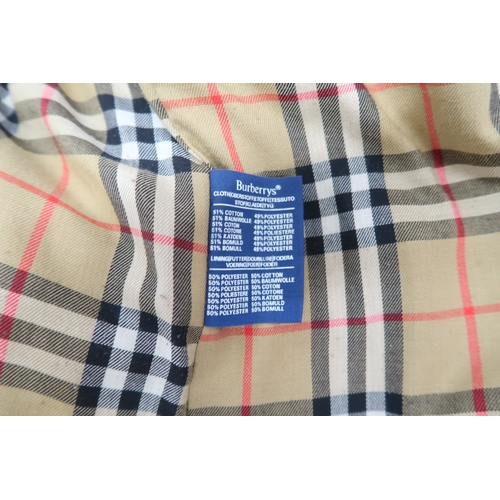 8030 - A vintage Burberry trench coat with belt, lined in nova check pattern