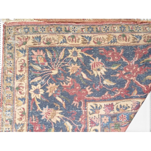 2080 - AN IMPRESSIVE LARGE RED GROUND SAROUK RUG with all-over floral/foliate patterned ground within dark ... 