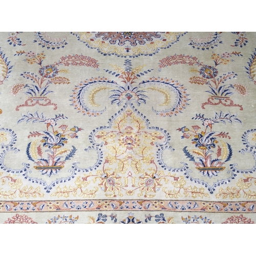 2081 - A LIGHT GREEN GROUND FINE PILE TABRIZ RUGwith beige sunburst central medallion and lighter spandrels... 