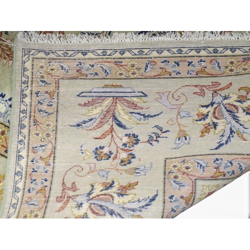 2081 - A LIGHT GREEN GROUND FINE PILE TABRIZ RUGwith beige sunburst central medallion and lighter spandrels... 