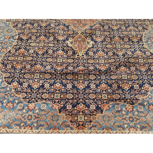 2083 - A DARK BLUE GROUND FINE PILE MAHAL RUGwith pink and cream diamond form central medallion and light b... 