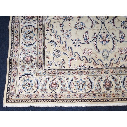 2084 - AN IVORY GROUND FINE NAIN RUGwith light blue sunburst central medallion on floral/foliate patterned ... 