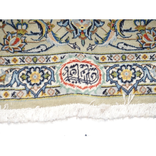 2085 - A CREAM GROUND FINE PILE KASHAN RUGwith multicoloured sunburst central medallion on extensive floral... 