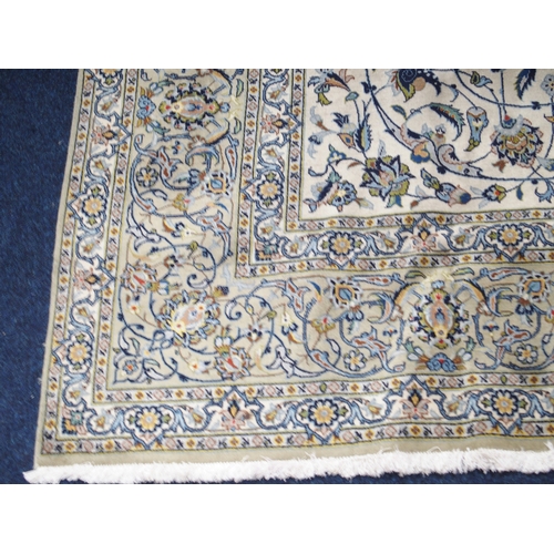 2085 - A CREAM GROUND FINE PILE KASHAN RUGwith multicoloured sunburst central medallion on extensive floral... 