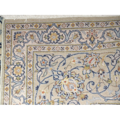 2085 - A CREAM GROUND FINE PILE KASHAN RUGwith multicoloured sunburst central medallion on extensive floral... 