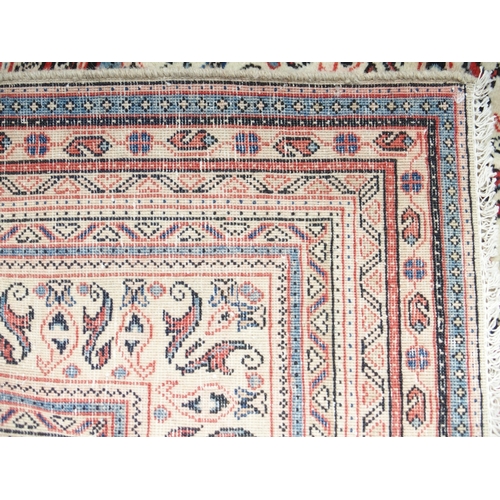 2086 - A LARGE CREAM GROUND DEEP PILE MAHAL RUGwith all-over multicoloured geometric patterned ground withi... 