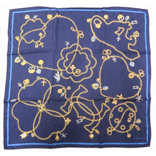 8050 - A Cartier silk scarf with design of gold chains and charms on dark blue groundwith box and authentic... 