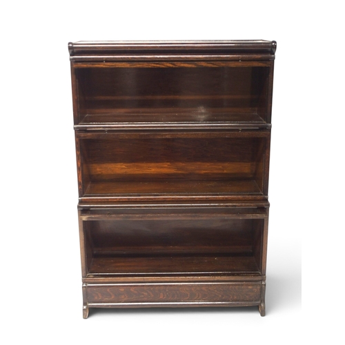 2001 - AN EARLY 20TH CENTURY OAK THREE TIER SECTIONAL BOOKCASE&nbsp;with three glazed front sections on pli... 