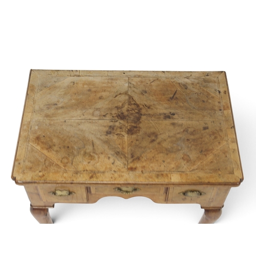 2004 - A GEORIGIAN BURR WALNUT VENEERED LOW BOY TABLEwith quarter veneered top over one long flanked by two... 