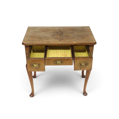 2004 - A GEORIGIAN BURR WALNUT VENEERED LOW BOY TABLEwith quarter veneered top over one long flanked by two... 