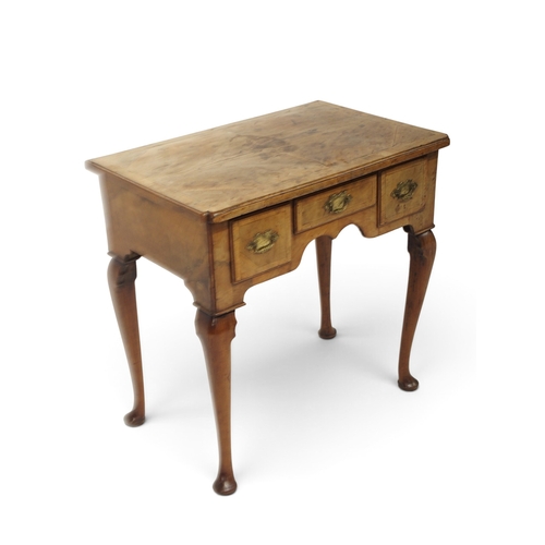 2004 - A GEORIGIAN BURR WALNUT VENEERED LOW BOY TABLEwith quarter veneered top over one long flanked by two... 