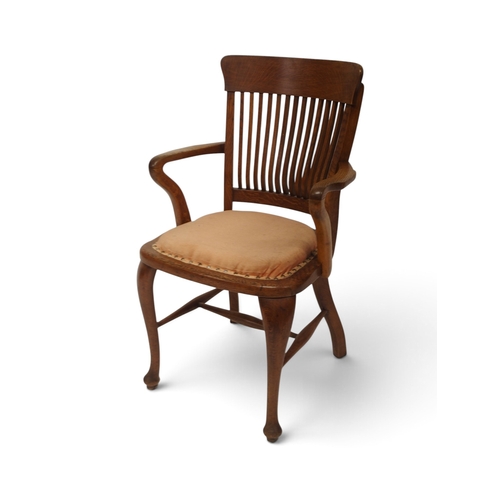2005 - AN EARLY 20TH CENTURY OAK ARTS & CRAFTS STYLE COMB BACK DESK ARMCHAIR&nbsp;with shaped arms flan... 