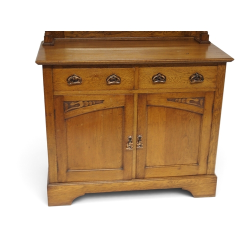 2006 - A LATE 19TH CENTURY OAK ARTS & CRAFTS MIRROR BACKED SIDEBOARDwith arched carved surmount over re... 
