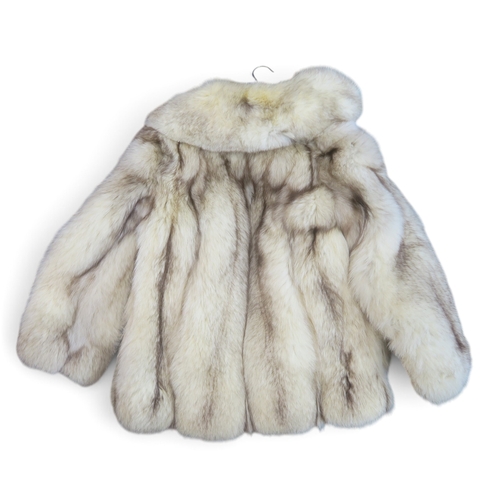 8049 - An arctic fox jacket by Giddings Furs Harrow; together with an Astraka faux fur coat, a wool and cas... 