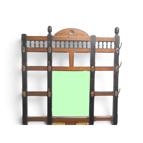 2017 - A LATE 19TH CENTURY OAK AND EBONISED ARTS & CRAFTS MIRROR BACKED HALLSTANDwith spindle mounted s... 
