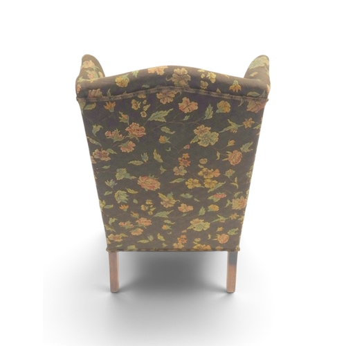 2020 - AN EARLY 20TH CENTURY BROWN FLORAL UPHOLSTERED WINGBACK ARMCHAIR&nbsp;with rolled arms on cabriole s... 