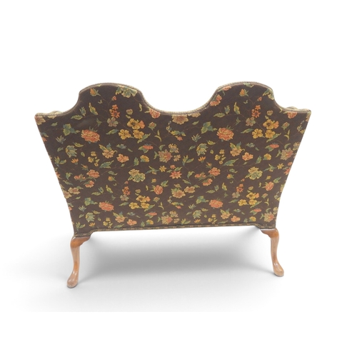 2021 - A 19TH CENTURY CONTINENTAL FLORAL UPHOLSTERED HUMPED WINGBACK SETTEEwith rolled arms on three carved... 