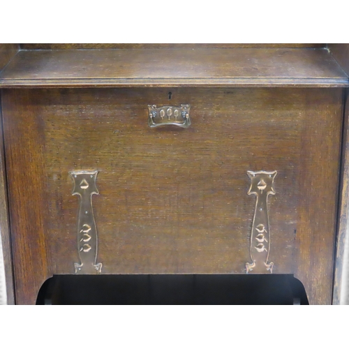 2030 - A LATE 19TH CENTURY OAK ARTS & CRAFT WRITING BUREAUwith galleried top over embossed copper mount... 