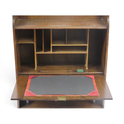 2030 - A LATE 19TH CENTURY OAK ARTS & CRAFT WRITING BUREAUwith galleried top over embossed copper mount... 