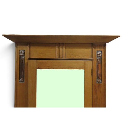 2033 - AN EARLY 20TH CENTURY OAK ARTS & CRAFTS TWO PIECE BEDROOM SUITEcomprising wardrobe with sloped c... 