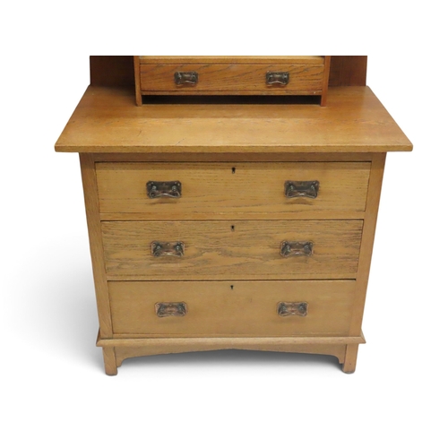 2033 - AN EARLY 20TH CENTURY OAK ARTS & CRAFTS TWO PIECE BEDROOM SUITEcomprising wardrobe with sloped c... 