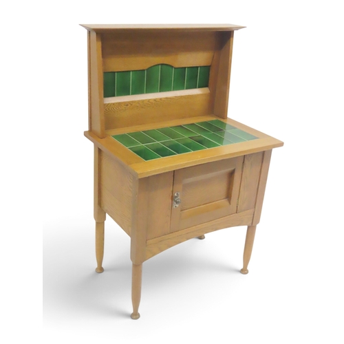2037 - AN EARLY 20TH CENTURY OAK ARTS & CRAFTS STYLE WASH STAND&nbsp;with stylized tile inset splashbac... 