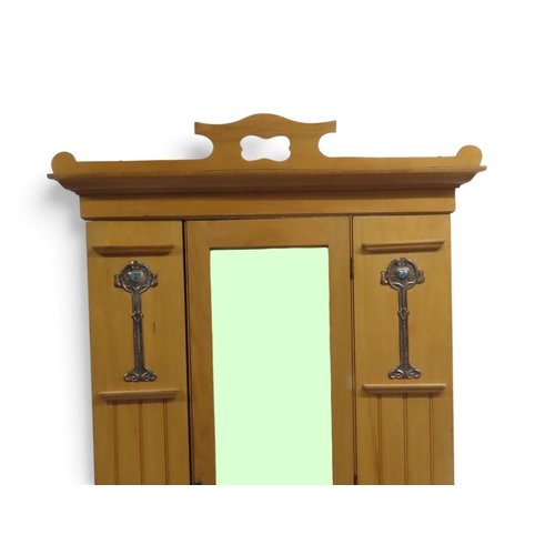 2038 - AN EARLY 20TH CENTURY BEECH ARTS & CRAFTS STYLE WARDROBEwith pierced moulded cornice over single... 