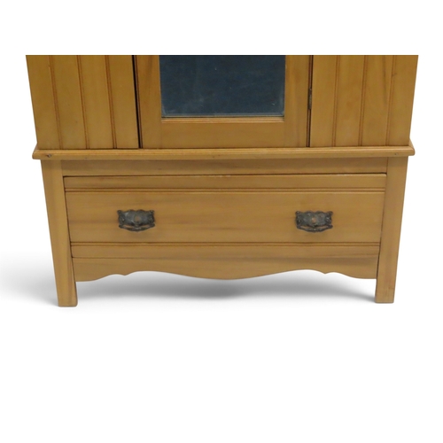 2038 - AN EARLY 20TH CENTURY BEECH ARTS & CRAFTS STYLE WARDROBEwith pierced moulded cornice over single... 