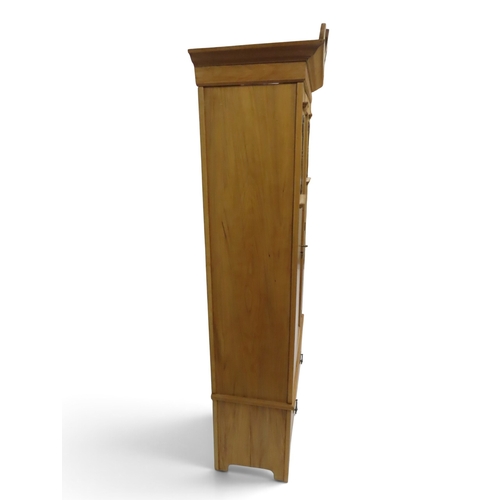 2038 - AN EARLY 20TH CENTURY BEECH ARTS & CRAFTS STYLE WARDROBEwith pierced moulded cornice over single... 