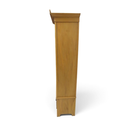 2038 - AN EARLY 20TH CENTURY BEECH ARTS & CRAFTS STYLE WARDROBEwith pierced moulded cornice over single... 