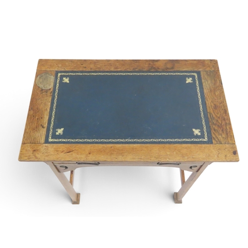 2039 - A 19TH CENTURY OAK ARTS & CRAFTS LADIES WRITING DESK&nbsp;with blue embossed skiver top over sin... 