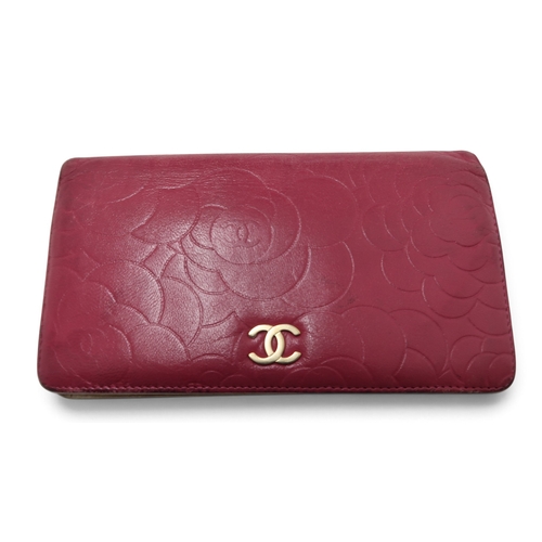 8057 - A Chanel Camellia long wallet in pink lambskin with gold-tone hardware With Chanel authenticity card... 