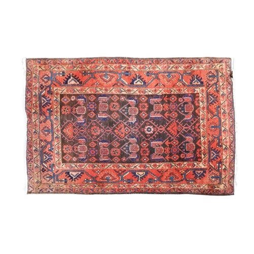 14 - A dark ground Hamadan rug with geometric patterned ground within multicoloured geometric patterned b... 