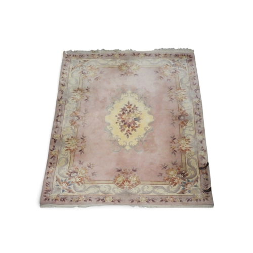 2 - A large deep pile pink ground Oriental style rug with cream floral decorated central medallion withi... 