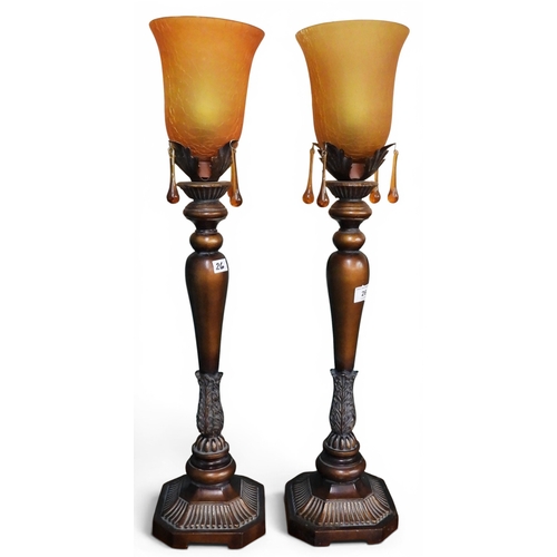26 - A pair of contemporary copper toned table lamps with crackle glaze shades on acanthus decorated upri... 